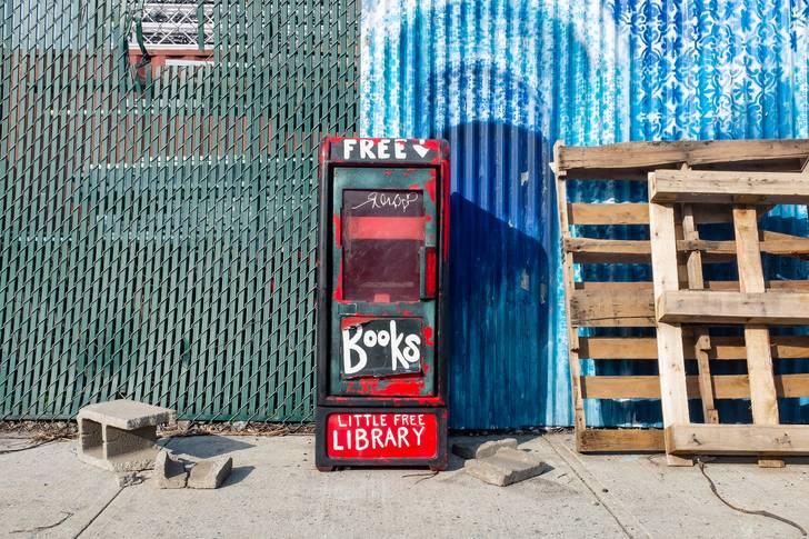 A photo of a free library stand outside the art center Pioneer Works on King Street near Conover Street.